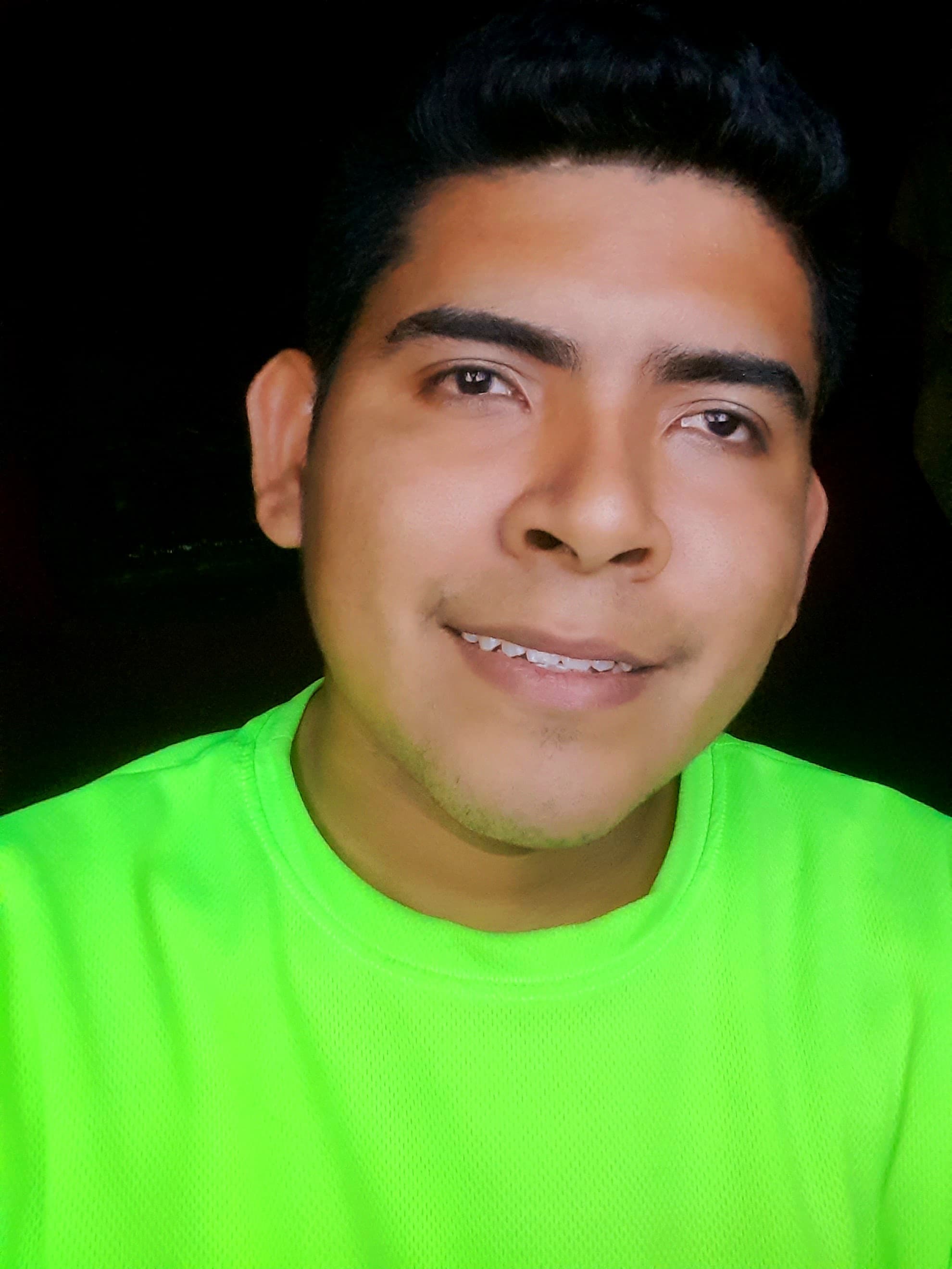 invitado del instituto universitario mayor de Cartagena Lewis Germán Julio Arango, quien viste una camisa de Color verde, Lewis sonríe