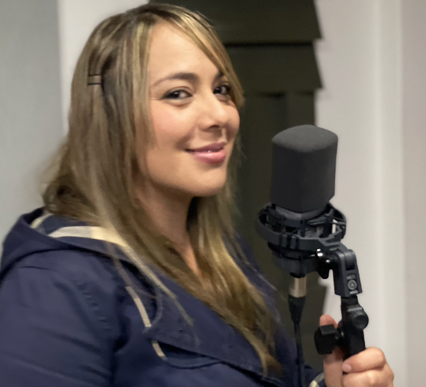 imagen Adriana pardo sonríe mientras sostiene el micrófono
