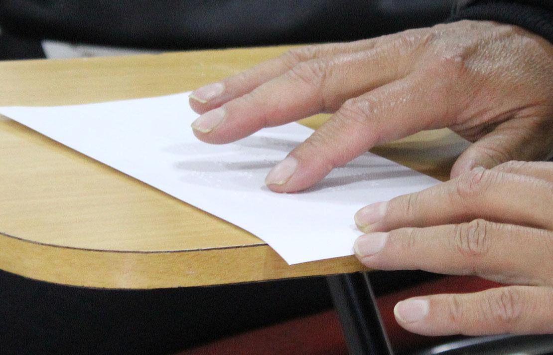 Fotografía, persona con discapacidad visual, leyendo braille