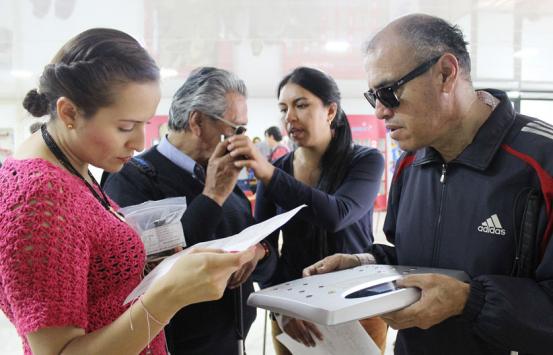 Personas con discapacidad visual conociendo los productos de la tienda